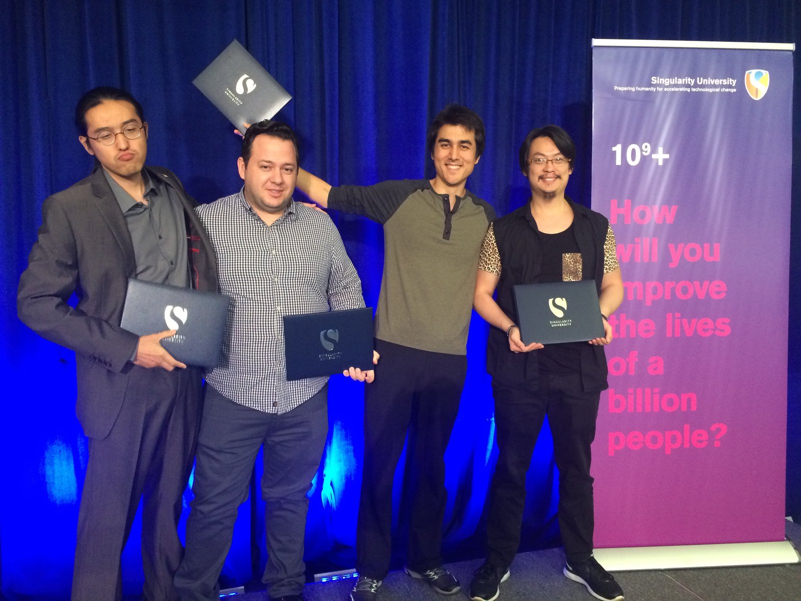 Wes and classmates holding Singularity University folders